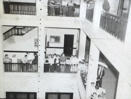 Interior Dorm and Kaye Hall Pictures 1955: Students Standing Around Guardrail of Upper Floor of Hall