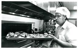 Kitchen Staff Pulling Food out of Oven (Part of the NMU Historic Photographs Collection)