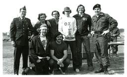 Two Men in Military Uniforms and Theta Chi Members Posing with Trophy (Part of the NMU Historic Photographs Collection)