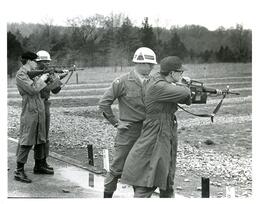 Four Men in Military Uniforms Shooting Guns Outside (Part of the NMU Historic Photographs Collection)