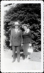 Man in Sunhat and Woman with Corsage