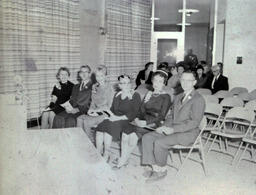 West Hall Dedication Fall 1960: Four Women, Two Men Sitting in Front Row (Different Lighting)