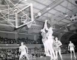 NMC Basketball--Aquinas Basketball 1960-61: Basketball Player Shooting Ball into Net