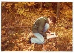 Competitor Kneeling in Woods (Part of the NMU Historic Photographs Collection)