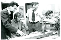 Professor and Students Watching a Man Use a Chisel (Part of the NMU Historic Photographs Collection)