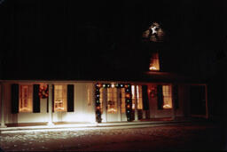 House Decorated For Christmas with Lights On Inside