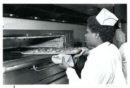 Kitchen Staff Pulling Food Out of Oven (Part of the NMU Historic Photographs Collection)