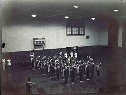 (022-005) Marching Band and Flag Twirler Performing in Gymnasium (2 of 2)