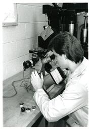 Student Looking into Microscope--Vocational Education (Part of the NMU Historic Photographs Collection)