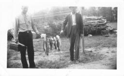 Andrew Benson, Sr. and Unknown Man with Caught Fish