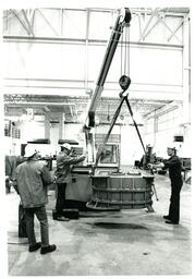 Men in Warehouse Lifting Large Metal Object with Crane (Part of the NMU Historic Photographs Collection)