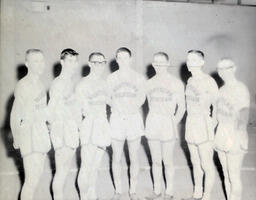 NMC Track Team 1961: Overexposed Photo of Seven Men in Track Uniforms