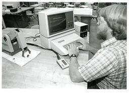 Student Programming Robot Arm with Early Computer (Part of the NMU Historic Photographs Collection)