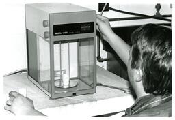 Man Operating a Mettler H80 Balance Gram Lab Scale (Part of the NMU Historic Photographs Collection)