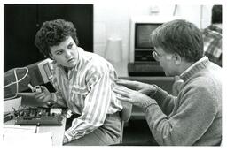 Professor and Student Speaking while Student Works with Electronics (Part of the NMU Historic Photographs Collection)