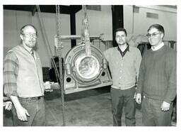 Three Men Posing with Car Part Raised on a Chain (Part of the NMU Historic Photographs Collection)