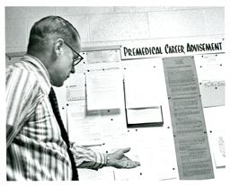 Dr. Wagner Showing Premedical Career Advisement Board (Part of the NMU Historic Photographs Collection)