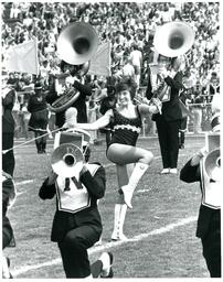 Baton Twirler Performing with Marching Band at Football Game (Part of the NMU Historic Photographs Collection)