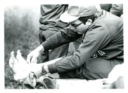 Man in Military Uniform Taping Ankles (Part of the NMU Historic Photographs Collection)