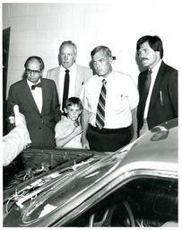 John X. Jamrich, Three Men, and Child Listening to Auto Professor (Part of the NMU Historic Photographs Collection)