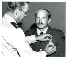 Lieutenant Colonel Taylor Pinning Medal onto Captain Bessler (Part of the NMU Historic Photographs Collection)