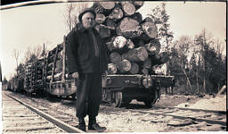 One Man in Front of Logs