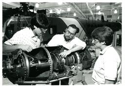 Professor and Students Looking at Plane Part (Part of the NMU Historic Photographs Collection)