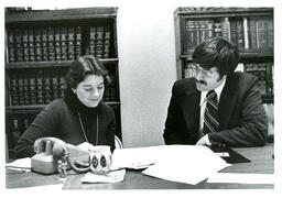 Two People Looking at Papers (Part of the NMU Historic Photographs Collection)