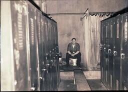 (033-002) Fully Clothed Man Sitting on Toilet