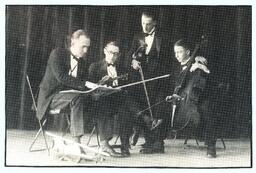 String Quartet Posing with Sheet Music and Instruments (Part of the NMU Historic Photographs Collection)