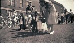 (008-024) Costumed Children, Marching Band, and Adults Standing on Lawn