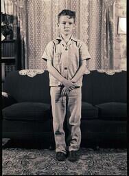 (048-004) The Oldest Chabot Boy Standing in front of Couch