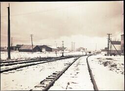 (019-006) Railroad Tracks with Buildings in Background