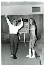 John X. Jamrich Posing with Baton next to Baton Twirler (Part of the NMU Historic Photographs Collection)