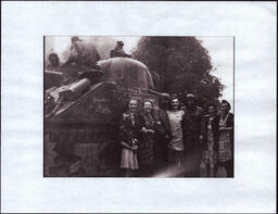 Civilian Women and Soldiers next to Tank