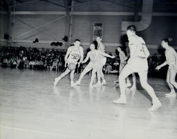 (128-01) Basketball NMC vs. Michigan Tech Feb. 24, 1960: Northern Player Driving Towards Basket