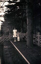 (007-012) Girl and Boy Standing on Steps Next to Tree