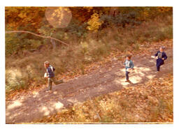 View from Above of Three Competitors Running Down a Road (Part of the NMU Historic Photographs Collection)