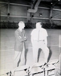 NMC - MSU Basketball Coaches and Officials February 4, 1961: Two Men on Side of Basketball Court