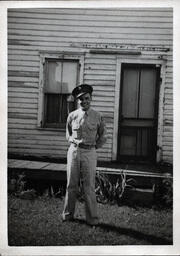 Tom Ross in Uniform Outside of House