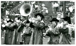 Line of Marching Band Members Performing at Football Game (Part of the NMU Historic Photographs Collection)