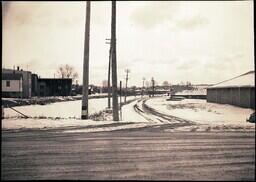 (019-002) Buildings, Telephone Poles, and Dirt Road in Ontonagon